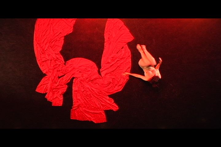 dancer kathy mancuso on red cloth, shot from above