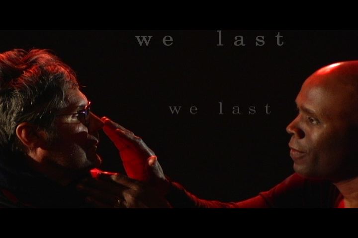 tom bayer and lynn manning, faces touching, with words 'we last' on the screen