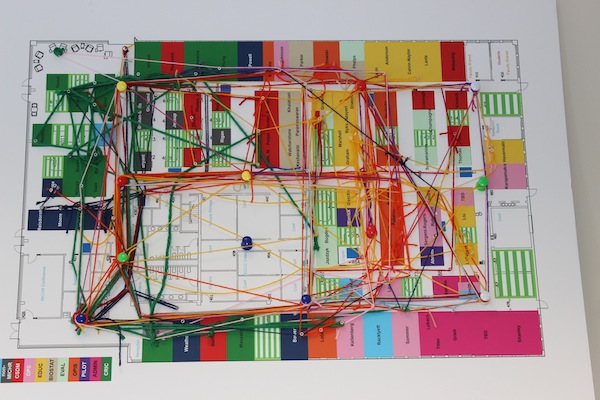 A network map made with yarn and push pins