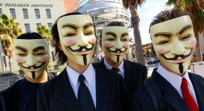 Photo of four people wearing Guy Fawkes masks, symbolizing a hactivist group