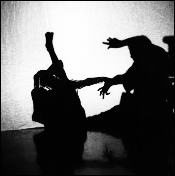 images of two performers in shadow play