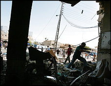 Iraqis in the Baghdad neighborhood of Suleikh sift through a cafe destroyed in a bombing unrelated to fighting in the Adhamiyah area. Police said at least seven people were killed and more than 20 wounded in the cafe bombing.
